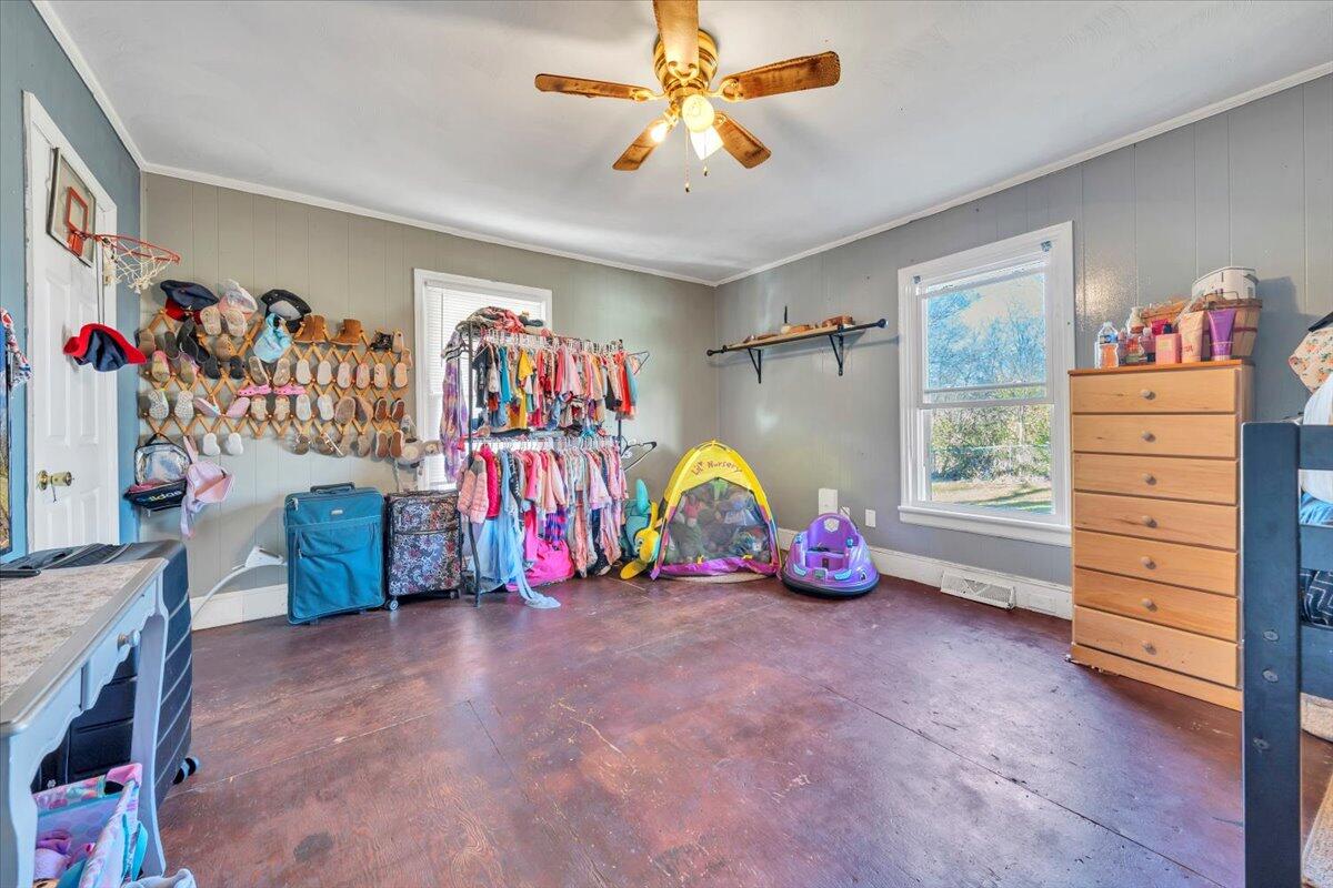 1319 Liberty Road Northeast Roanoke, VA 24012 - Photo 22 of 36 a view of an empty room with toys and a ceiling fan