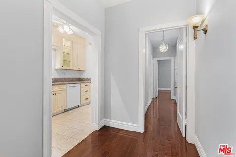 a kitchen with white cabinets and a window