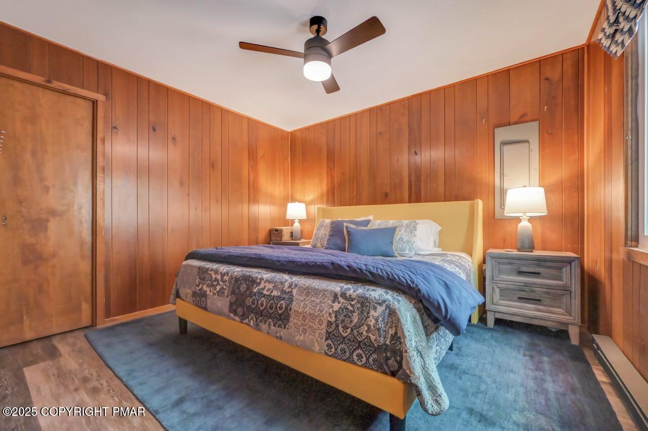 1169 Deer Trail Road Pocono Pines, PA 18350 - Photo 11 of 21 a spacious bedroom with a bed and a chandelier