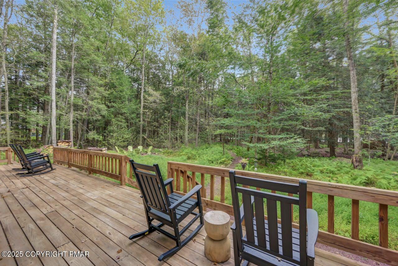 1169 Deer Trail Road Pocono Pines, PA 18350 - Photo 20 of 21 a view of a deck with two chairs and wooden floor