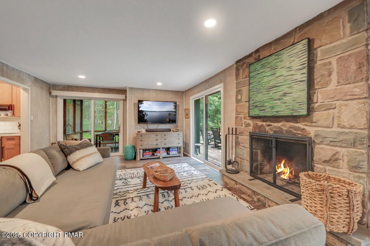 1169 Deer Trail Road Pocono Pines, PA 18350 - Photo 3 of 21 a living room with furniture a fireplace and a flat screen tv