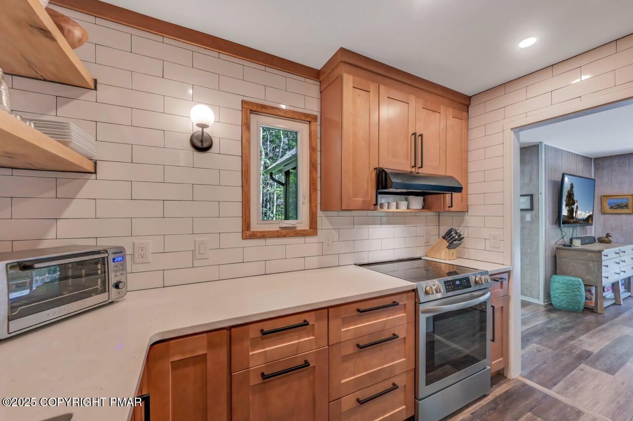 1169 Deer Trail Road Pocono Pines, PA 18350 - Photo 9 of 21 a kitchen with granite countertop a stove and a sink
