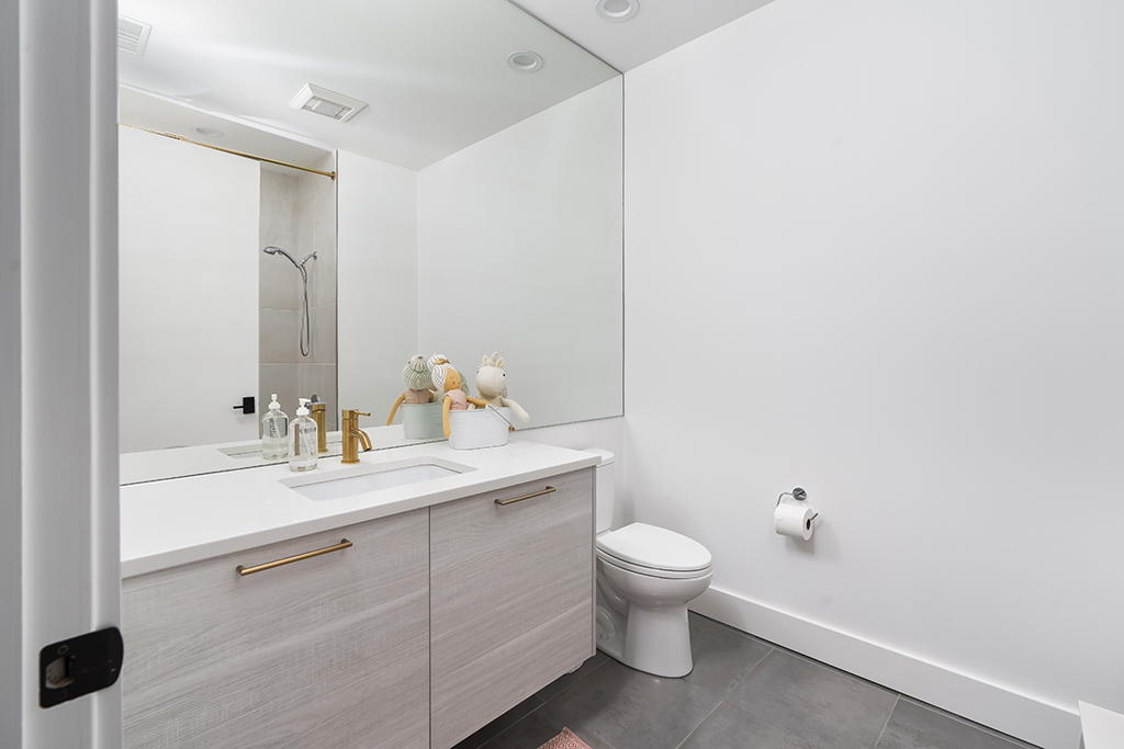 1132 West Adams Street, Unit 5W Chicago, IL 60607 - Photo 13 of 26 a bathroom with a sink mirror and toilet