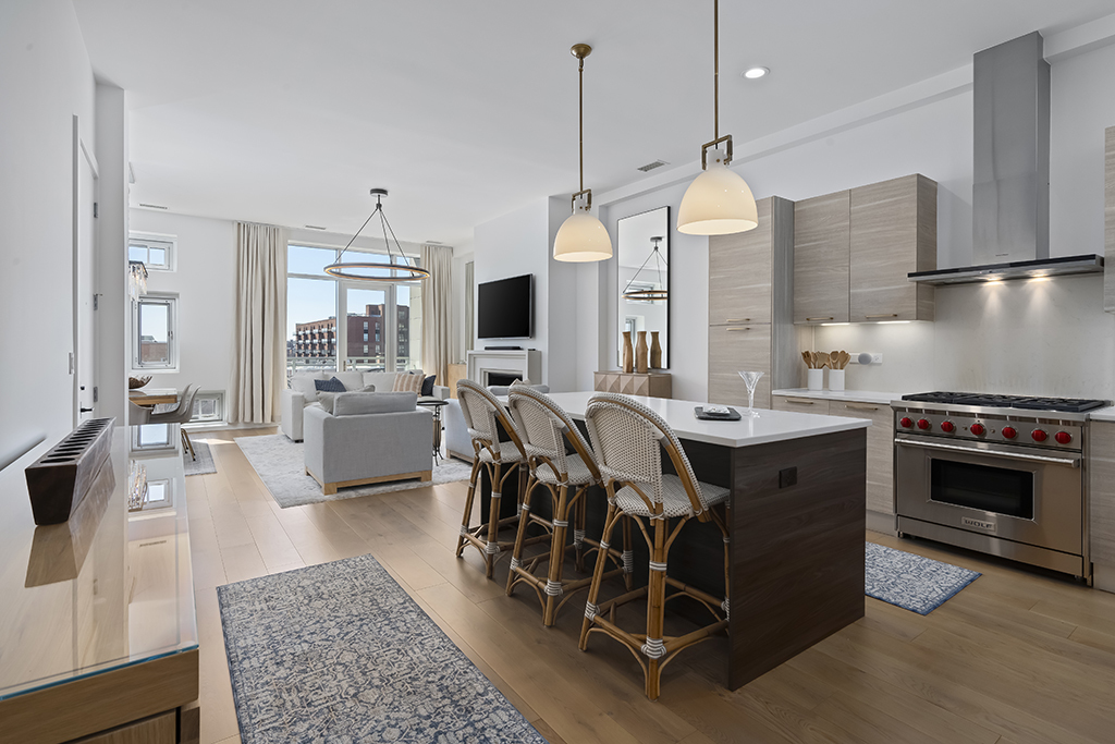 1132 West Adams Street, Unit 5W Chicago, IL 60607 - Photo 2 of 26 a kitchen with stainless steel appliances granite countertop a stove a sink dishwasher a dining table and chairs with wooden floor
