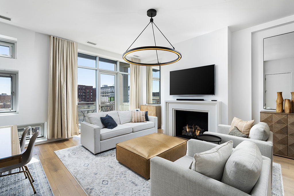 1132 West Adams Street, Unit 5W Chicago, IL 60607 - Photo 4 of 26 a living room with furniture a flat screen tv and a fireplace