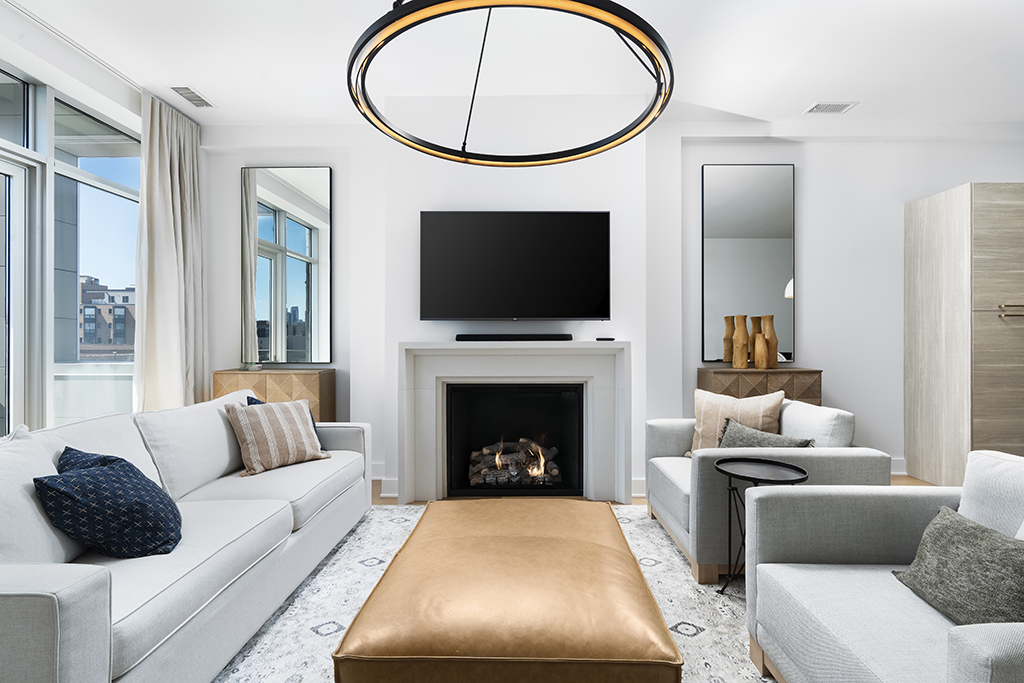 1132 West Adams Street, Unit 5W Chicago, IL 60607 - Photo 7 of 26 a living room with furniture a flat screen tv and a fireplace