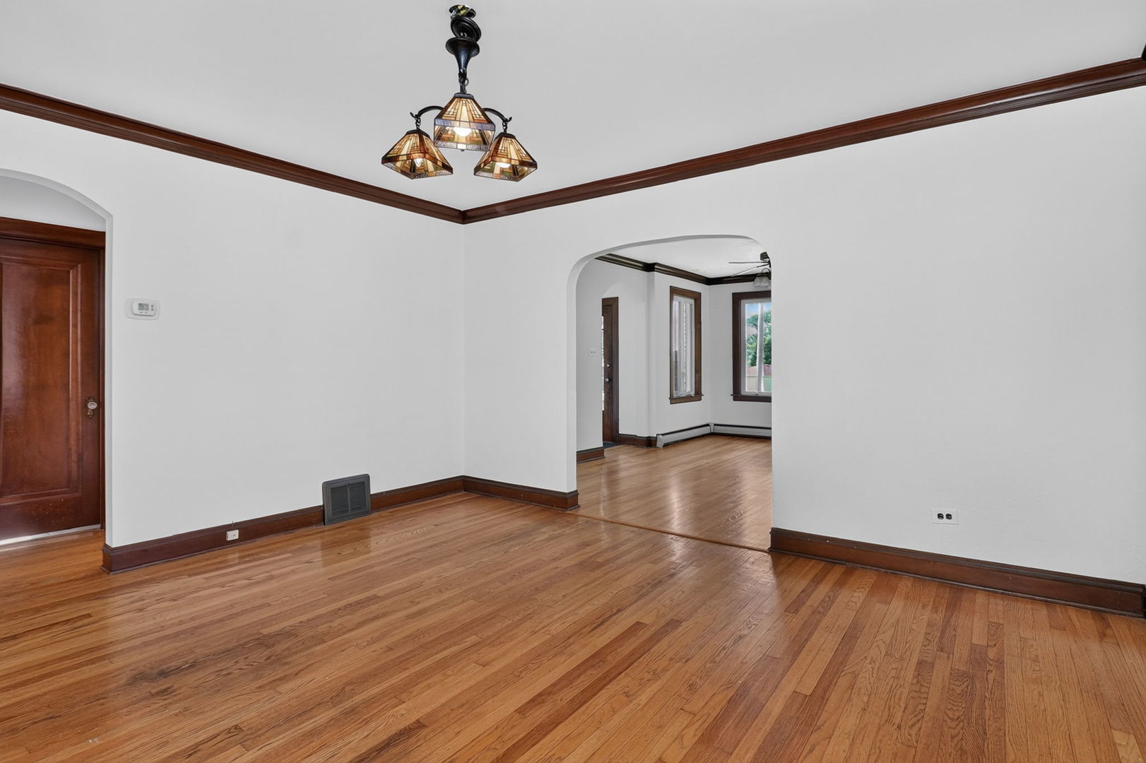708 McCarthy Road Lemont, IL 60439 - Photo 5 of 14 a view of empty room with wooden floor and fan