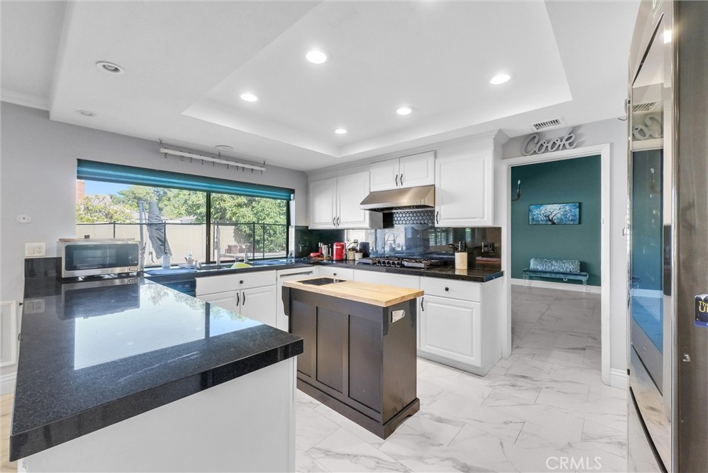 1417 West James Way Anaheim, CA 92801 - Photo 13 of 40 a kitchen with a sink stove and refrigerator