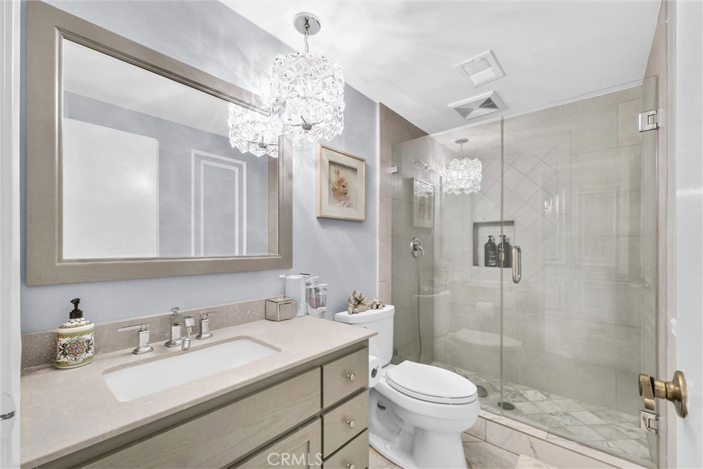 1417 West James Way Anaheim, CA 92801 - Photo 18 of 40 a bathroom with a sink toilet a mirror and shower