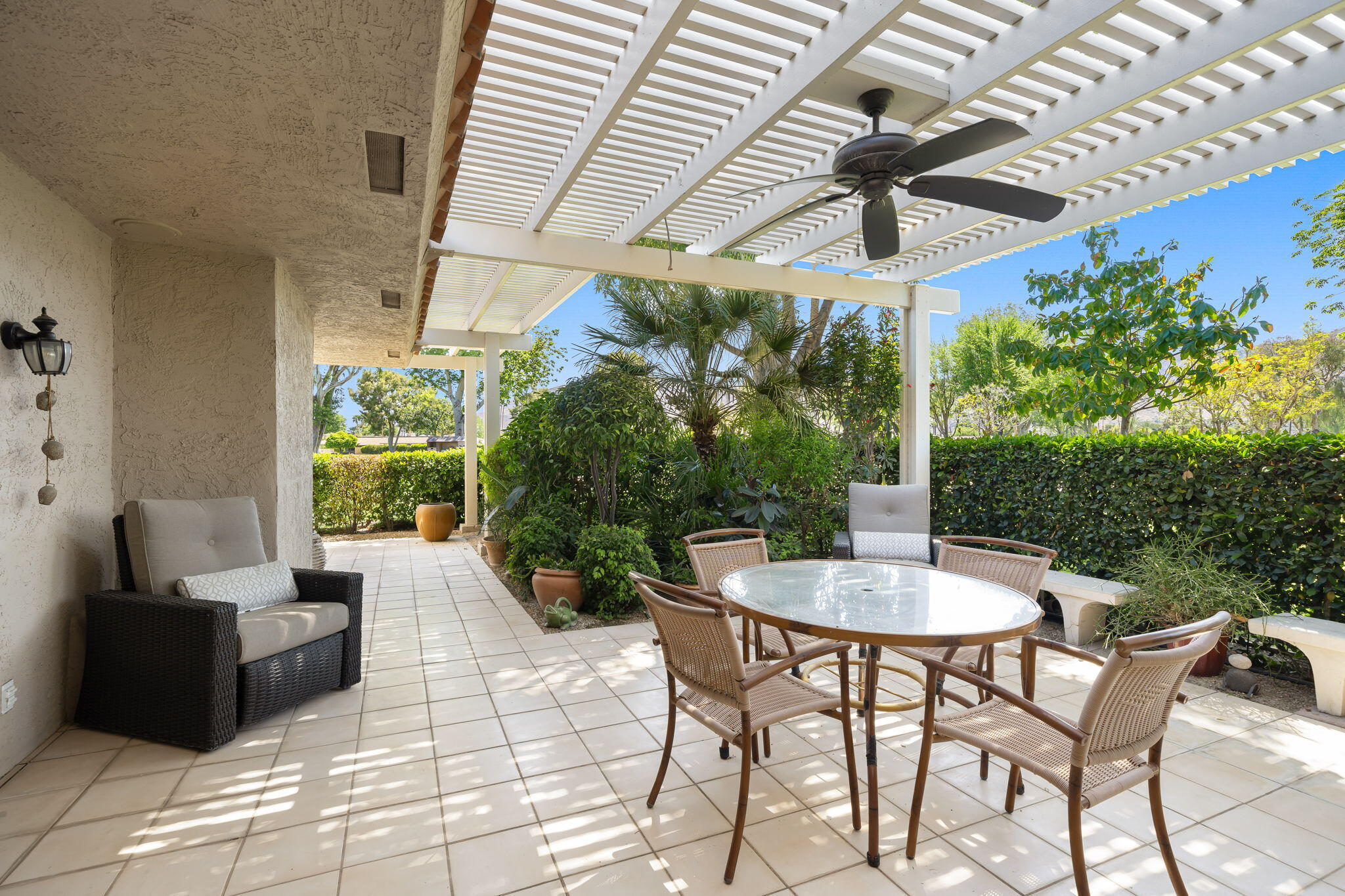 26 Stanford Drive Rancho Mirage, CA 92270 - Photo 28 of 39 a patio with a table and chairs and potted plants