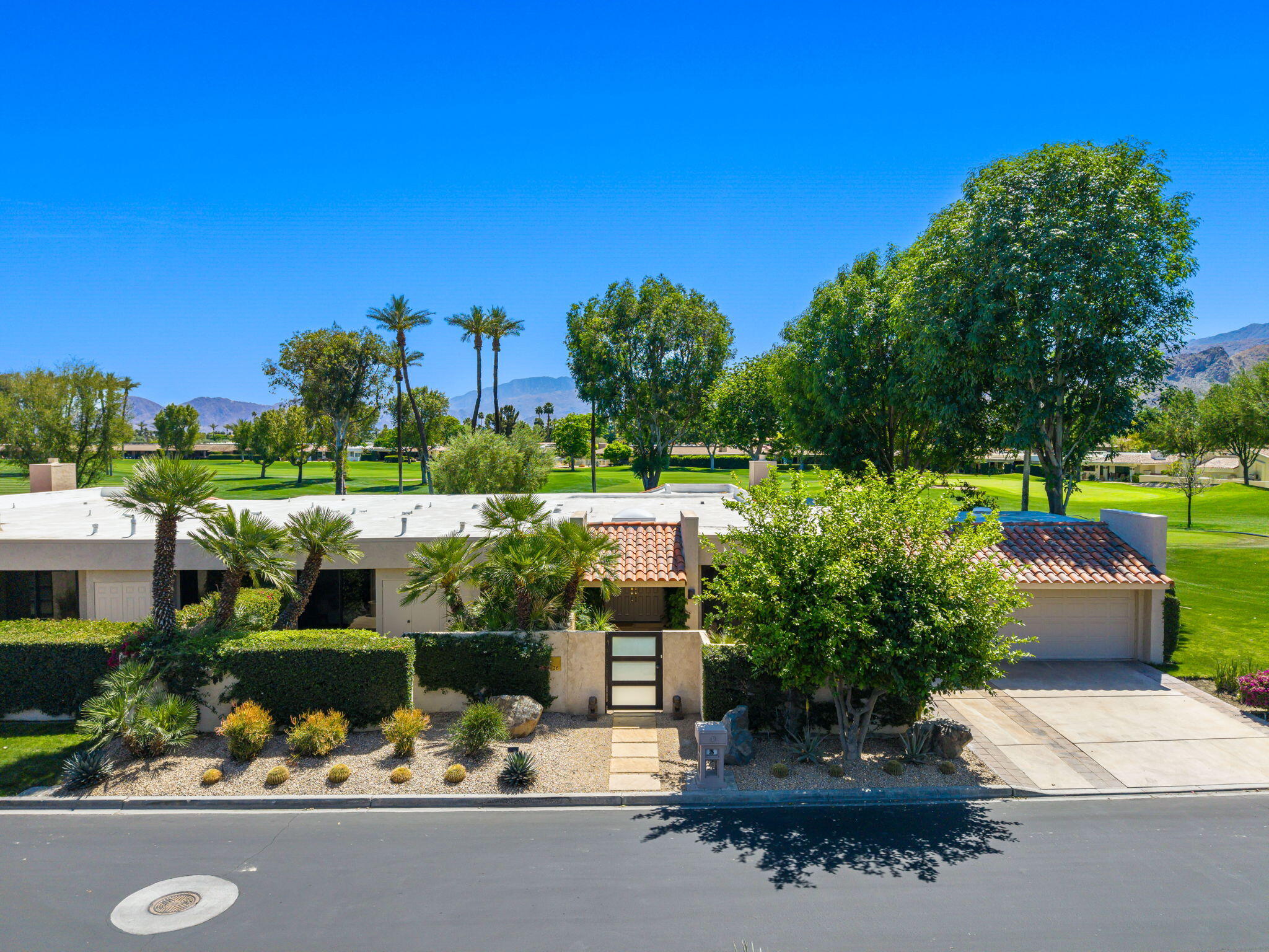 26 Stanford Drive Rancho Mirage, CA 92270 - Photo 32 of 39 a picture of a table and chairs in a garden