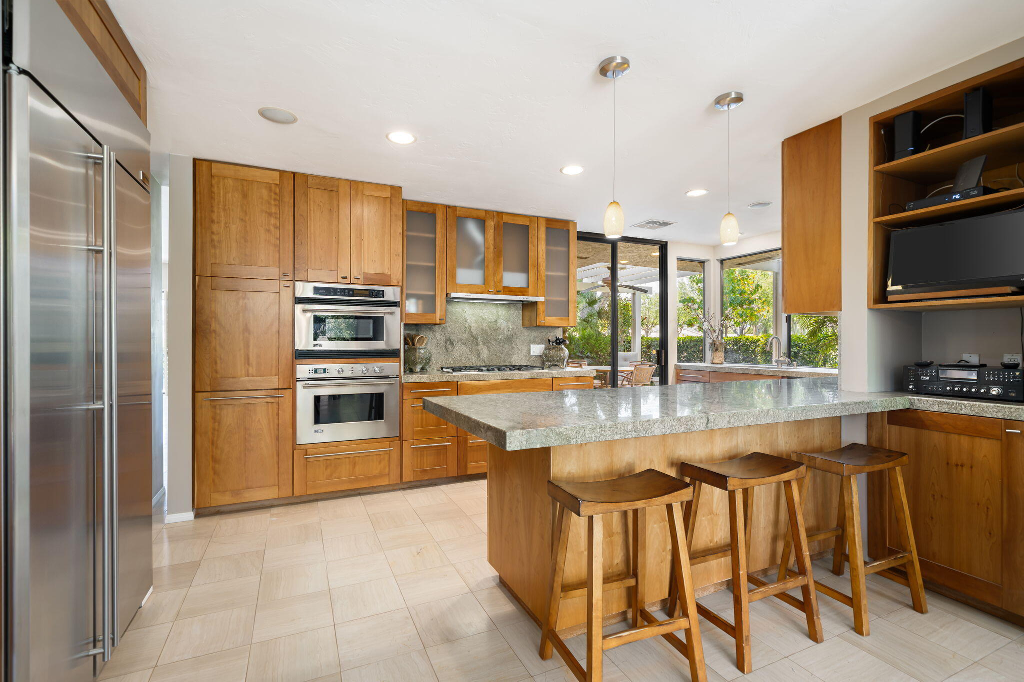 26 Stanford Drive Rancho Mirage, CA 92270 - Photo 9 of 39 a kitchen with stainless steel appliances granite countertop a stove top oven a sink and a refrigerator