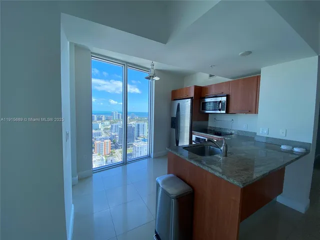 a kitchen with a sink cabinets and wooden floor