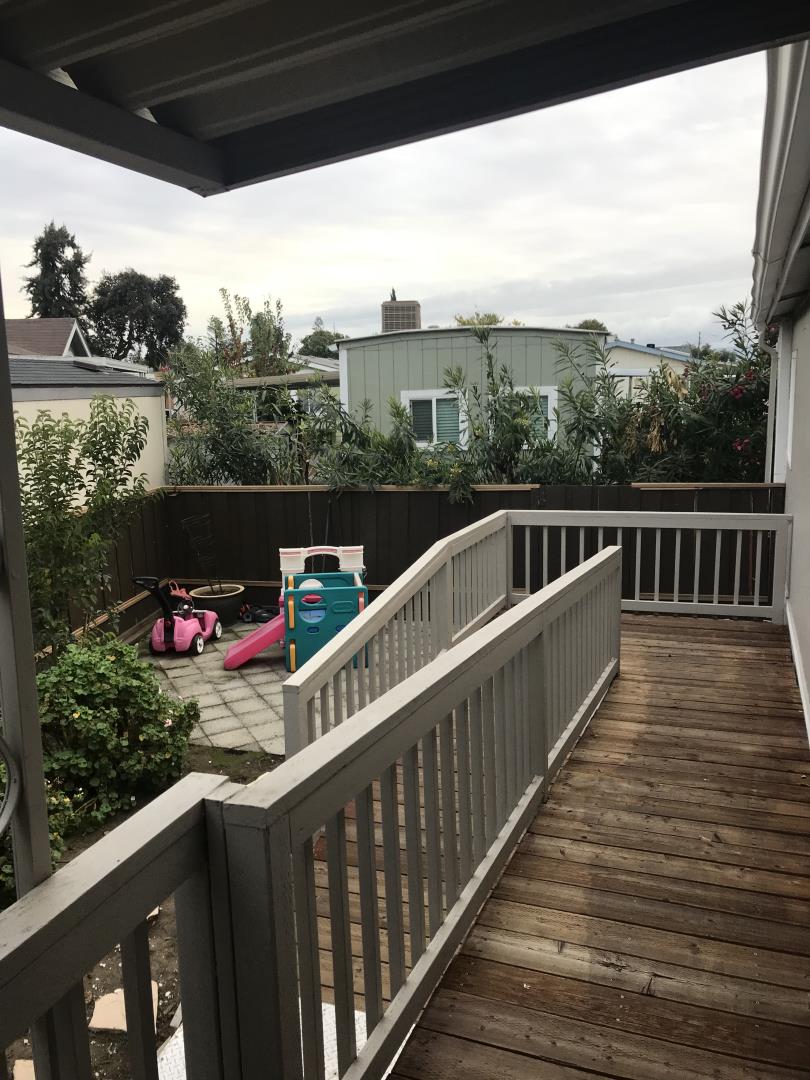 2151 Oakland Road, Unit 445 San Jose, CA 95131 - Photo 19 of 20 a view of a balcony with wooden floor and iron fence