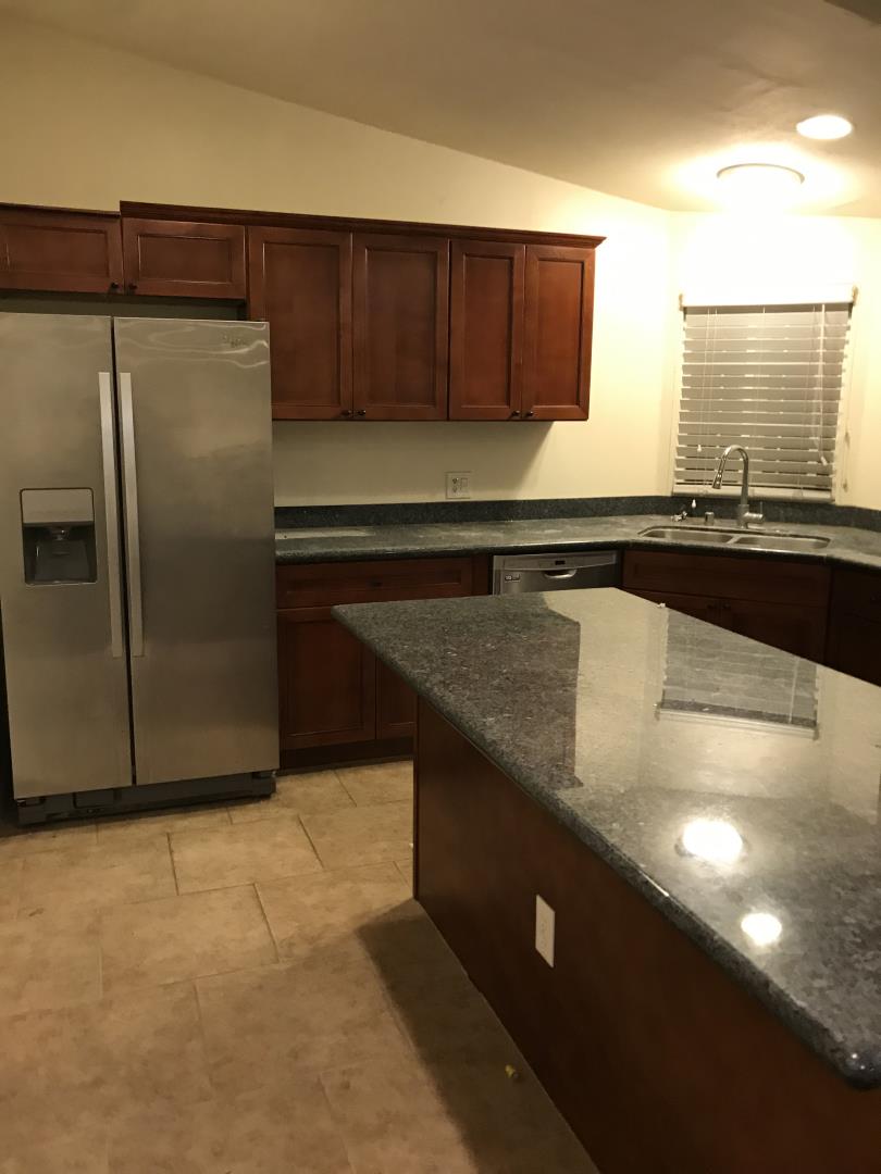 2151 Oakland Road, Unit 445 San Jose, CA 95131 - Photo 6 of 20 a kitchen with granite countertop a sink and a refrigerator