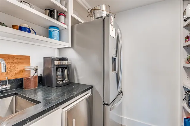 a kitchen with a refrigerator and a sink