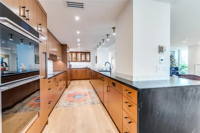 a large white kitchen with stainless steel appliances