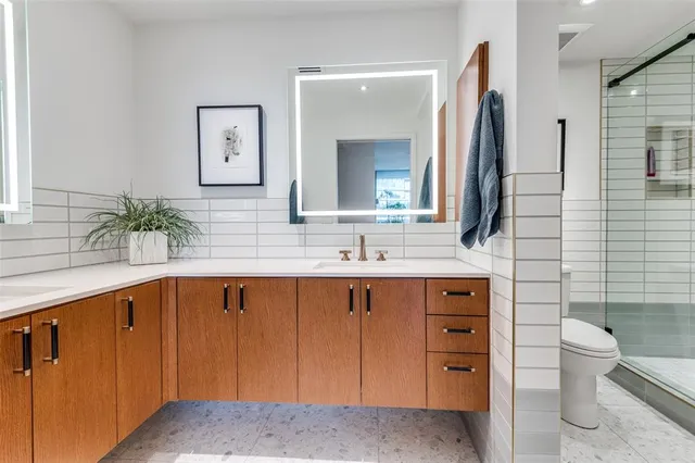 a spacious bathroom with a sink and a mirror