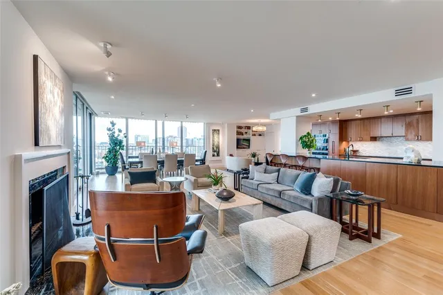 a living room with furniture a fireplace and a kitchen view