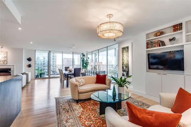 a living room with furniture kitchen view and a flat screen tv