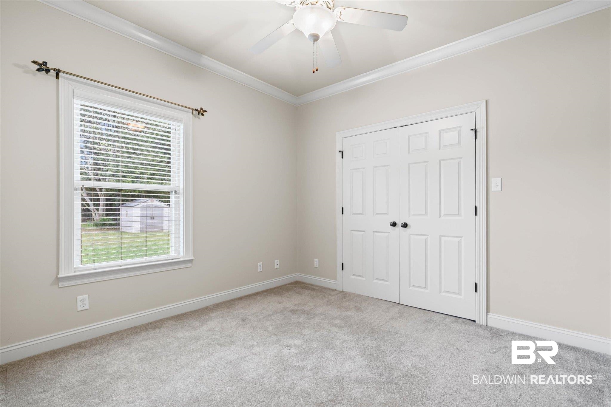 5270 Rodgers Road Eight Mile, AL 36613 - Photo 16 of 38 Unfurnished bedroom featuring ornamental molding, light colored carpet, a ceiling fan, and a closet