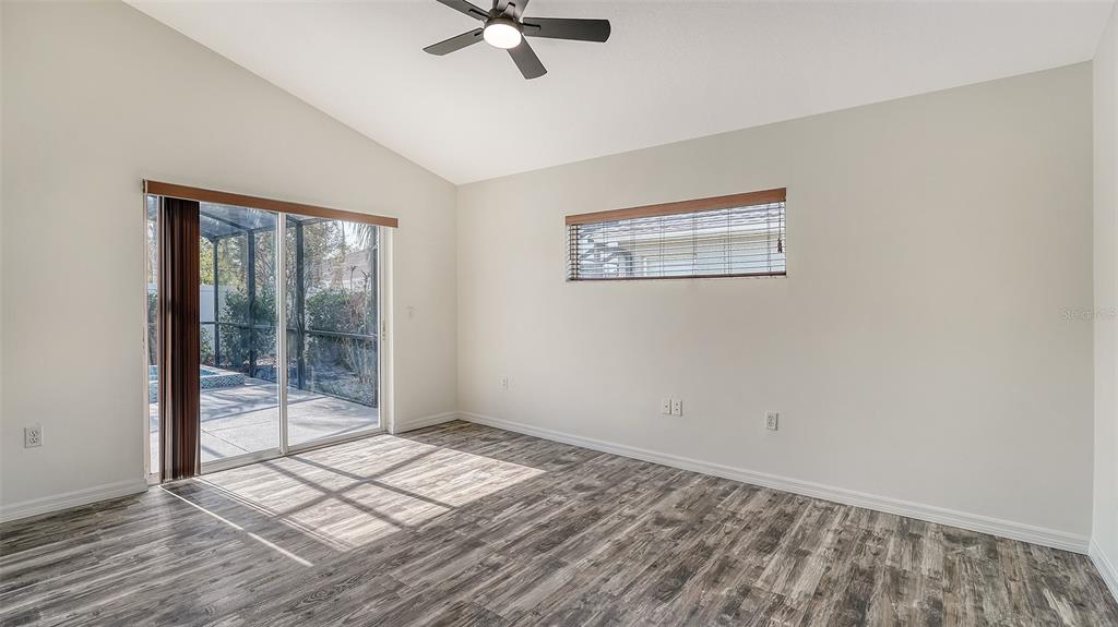 6213 Willet Court Lakewood Ranch, FL 34202 - Photo 16 of 74 a view of empty room with wooden floor and fan