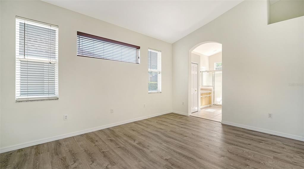 6213 Willet Court Lakewood Ranch, FL 34202 - Photo 18 of 74 an empty room with wooden floor and windows