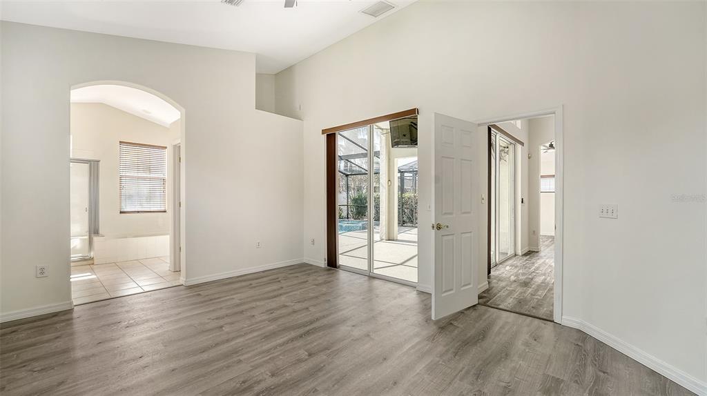 6213 Willet Court Lakewood Ranch, FL 34202 - Photo 19 of 74 an empty room with wooden floor and windows
