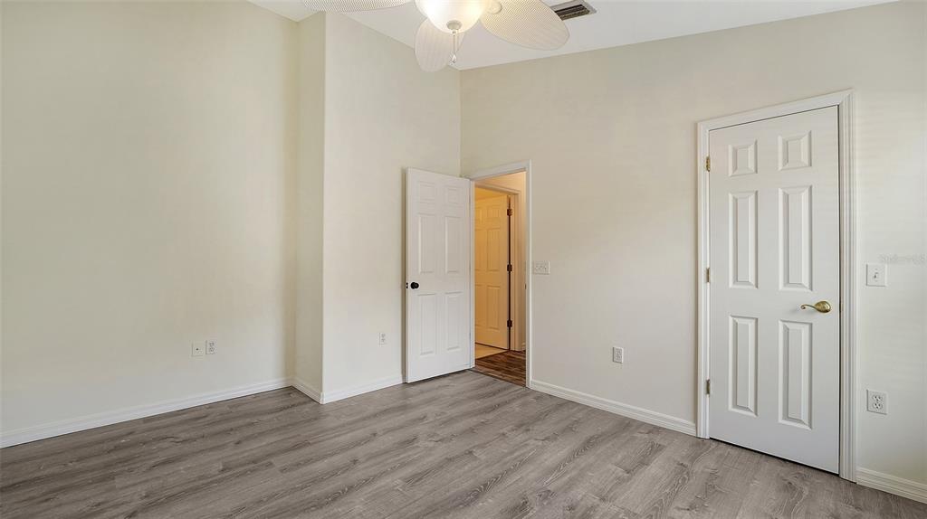 6213 Willet Court Lakewood Ranch, FL 34202 - Photo 25 of 74 a view of an empty room with wooden floor and closet