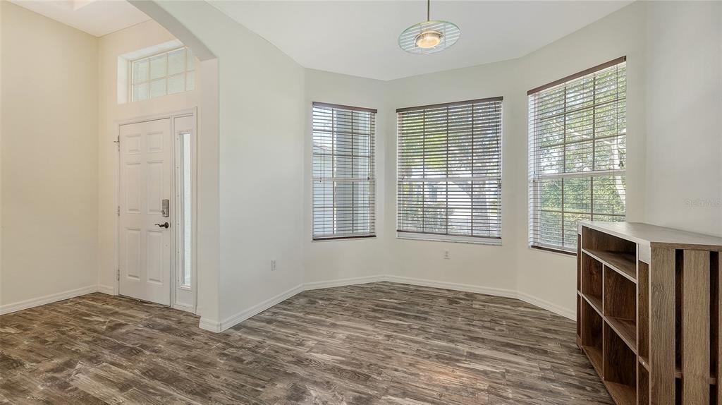 6213 Willet Court Lakewood Ranch, FL 34202 - Photo 4 of 74 a view of empty room with wooden floor and fan