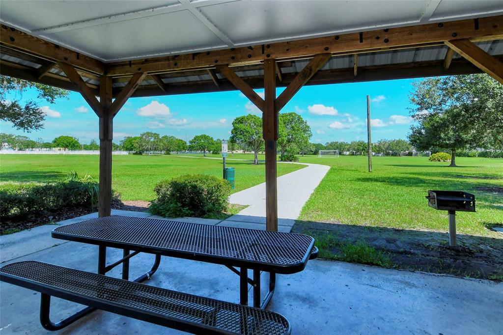 6213 Willet Court Lakewood Ranch, FL 34202 - Photo 48 of 74 a view of a porch with furniture and a yard