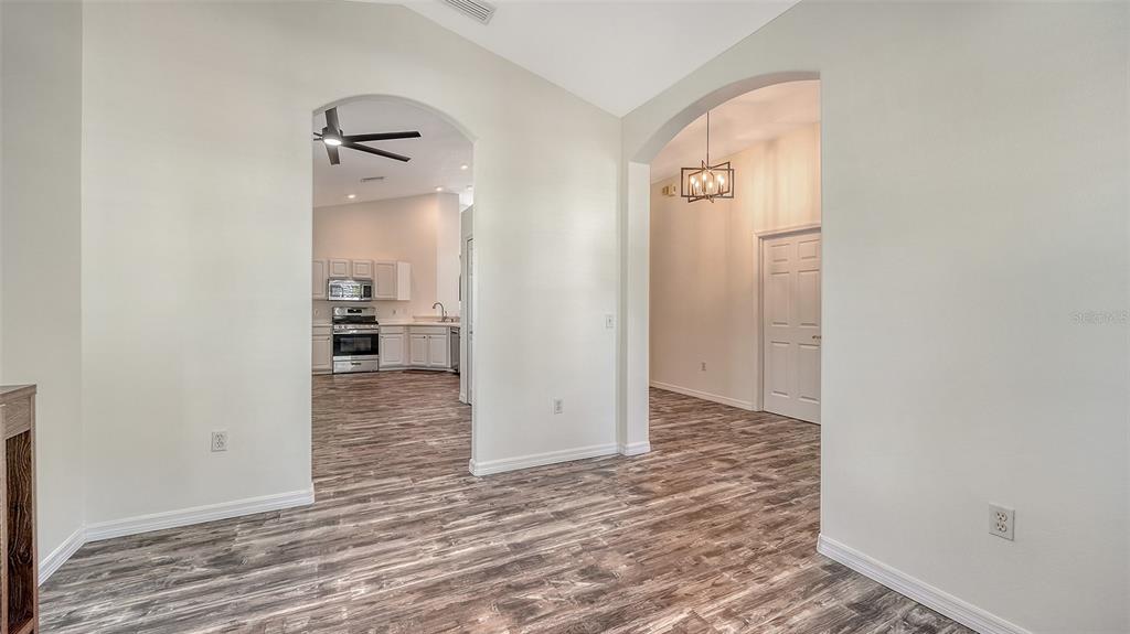 6213 Willet Court Lakewood Ranch, FL 34202 - Photo 5 of 74 an empty room with wooden floor and entrance