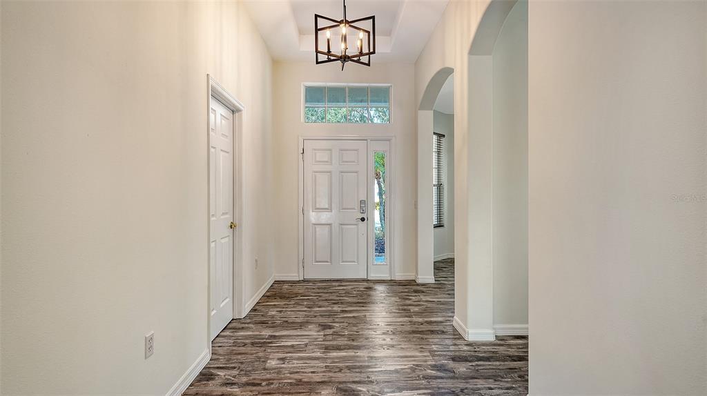 6213 Willet Court Lakewood Ranch, FL 34202 - Photo 6 of 74 a view of a hallway with wooden floor and entryway