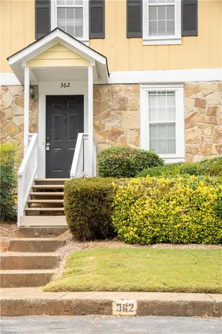 a view of a brick house with a white door