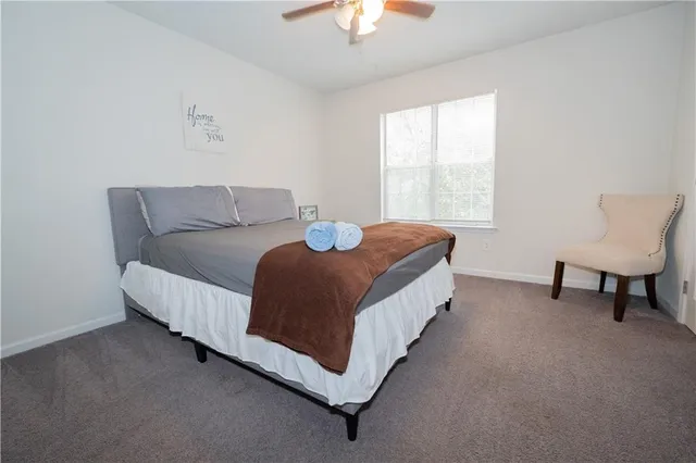 a living room with a bed furniture and a window