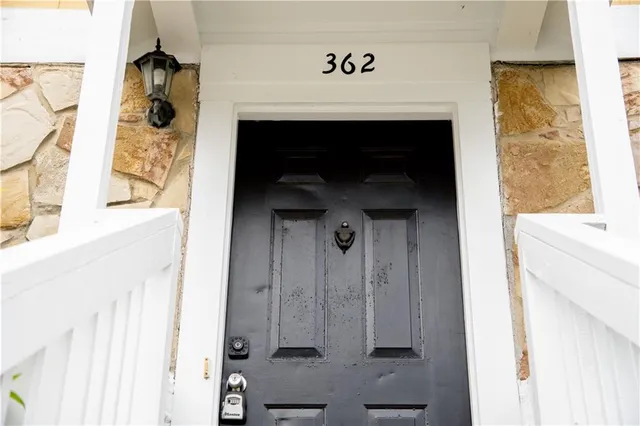 a hallway with windows and a fireplace