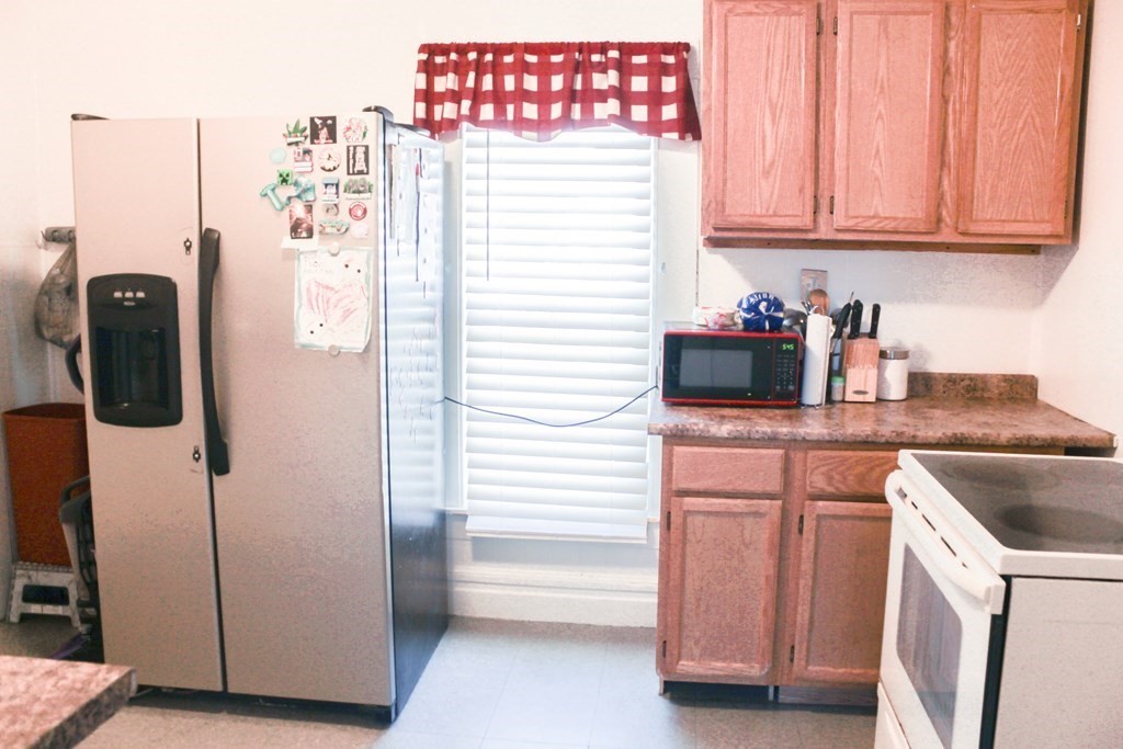 14 Cleveland Street Springfield, MA 01104 - Photo 6 of 14 a kitchen with a refrigerator and cabinets