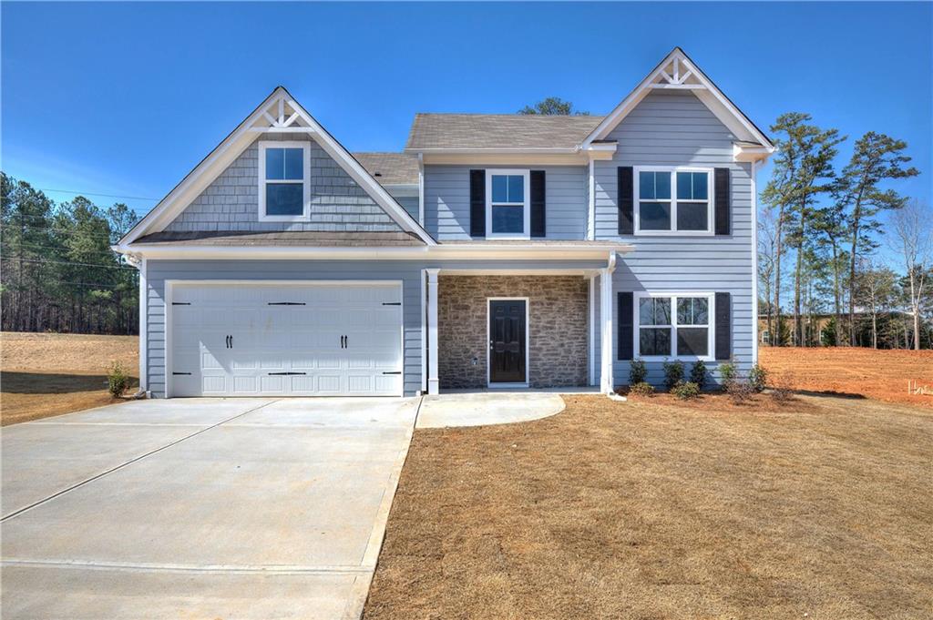 64 Elivia Way Dallas, GA 30132 - Photo 1 of 1 a front view of a house with a yard and garage