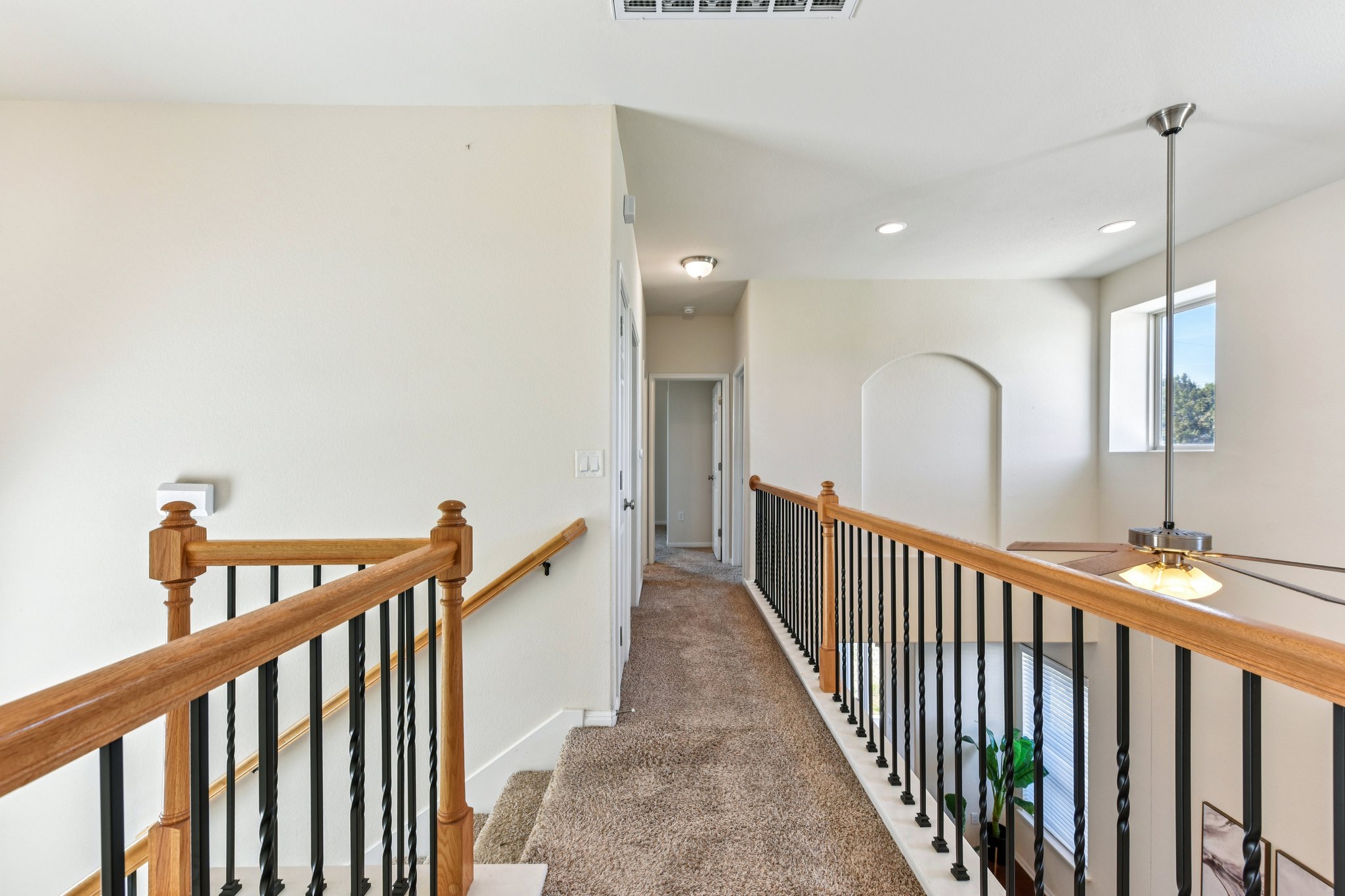 919 Boatswain Way Austin, TX 78748 - Photo 16 of 30 The upstairs catwalk keeps the layout private. The primary suite to the right, secondary bedrooms to the left.