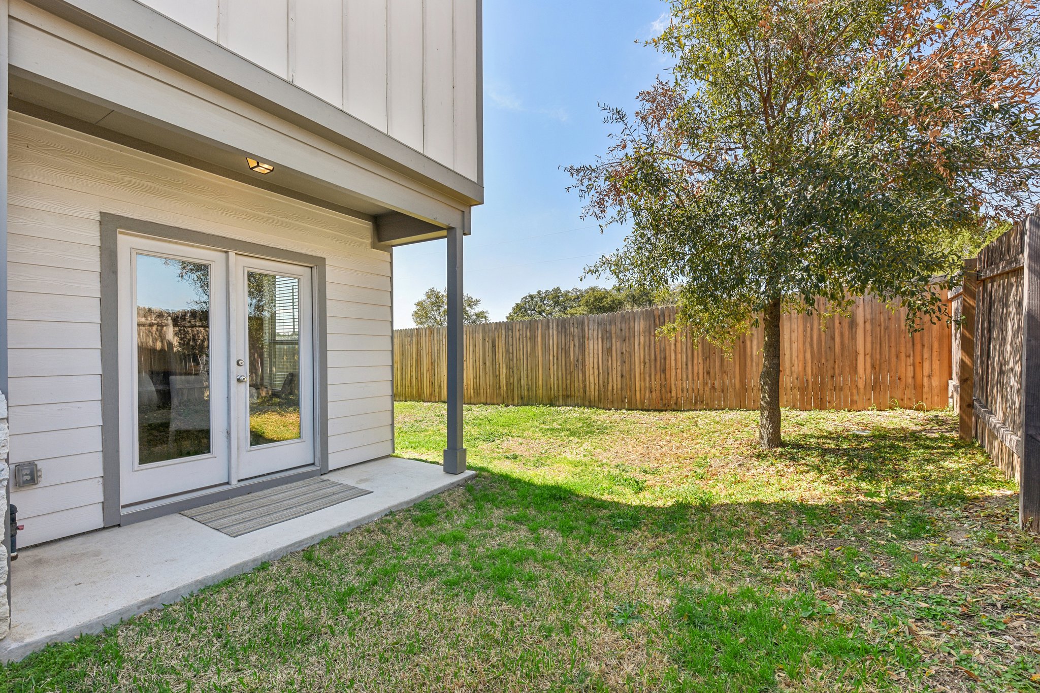 919 Boatswain Way Austin, TX 78748 - Photo 24 of 30 French doors open the main living area onto the covered back porch and a perfectly sized fenced-in backyard with privacy fencing.