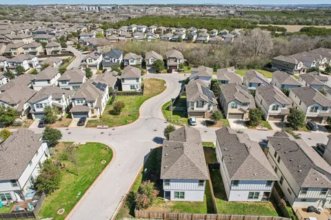 an aerial view of residential houses with outdoor space and river
