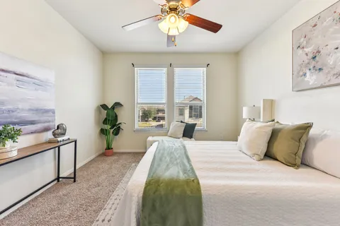a bedroom with a bed and a chandelier