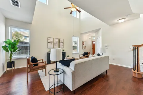 a living room with furniture and a wooden floor