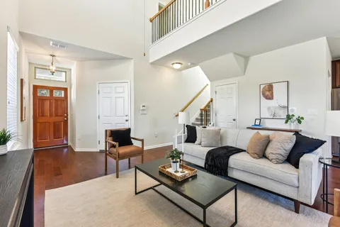 a living room with furniture and wooden floor