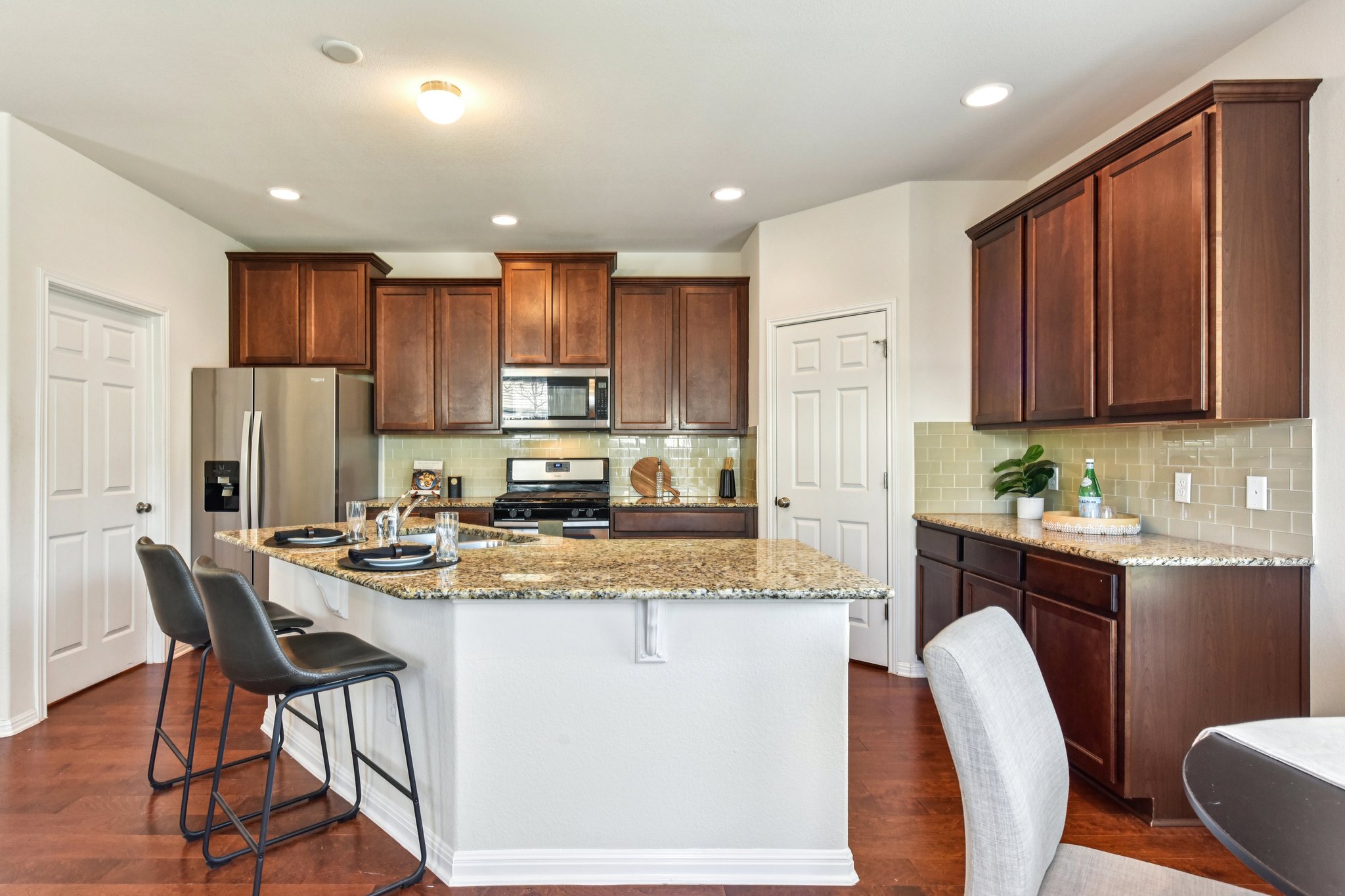 919 Boatswain Way Austin, TX 78748 - Photo 10 of 30 The oversized island is the natural gathering spot, snacks, chats, and “help me chop this” all happen right here.