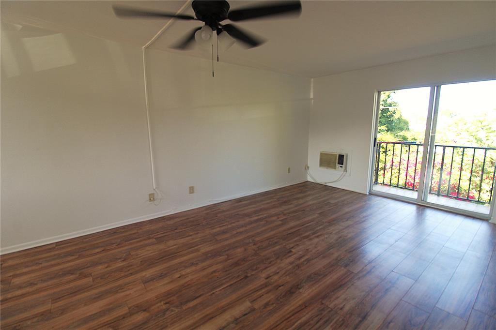 3101 Bee Ridge Road, Unit 215 Sarasota, FL 34239 - Photo 6 of 15 wooden floor in an empty room with a window