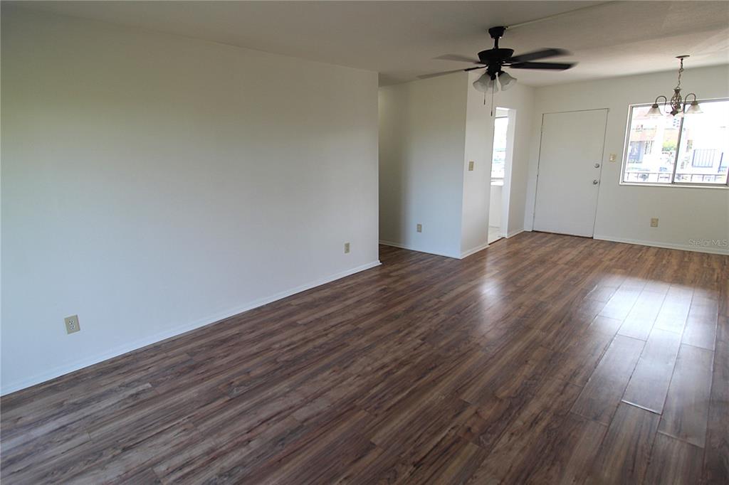 3101 Bee Ridge Road, Unit 215 Sarasota, FL 34239 - Photo 7 of 15 a view of empty room with wooden floor and fan