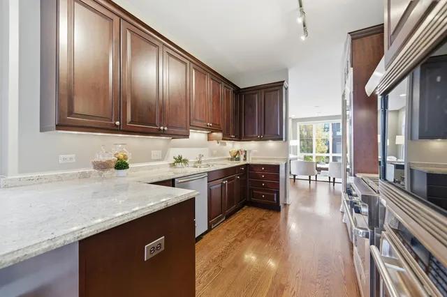 a kitchen with granite countertop a stove and cabinets