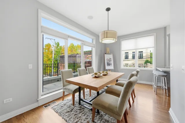 a view of a dining room with furniture window and wooden floor