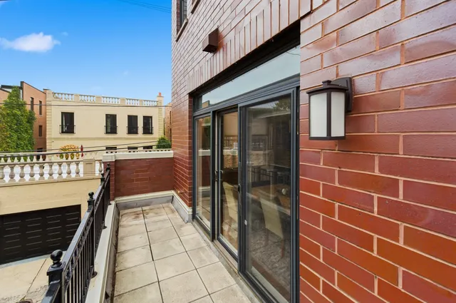 a kitchen with stainless steel appliances granite countertop a dining table chairs and refrigerator